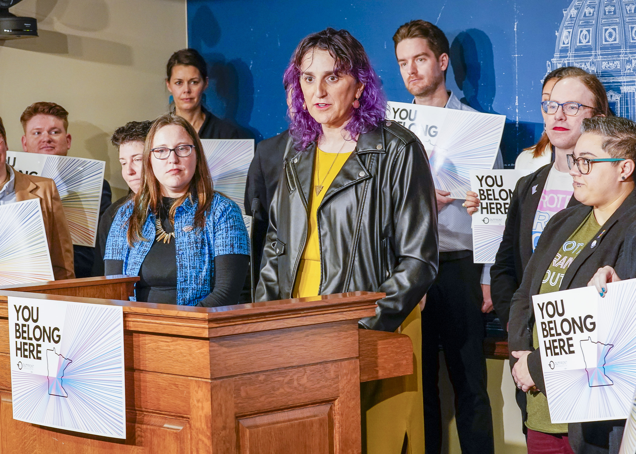 Surrounded by legislators and supporters, Rep. Leigh Finke answers questions regarding HF146 during a March 23 news conference. The House passed the bill before sunrise Friday. (Photo by Andrew VonBank) 